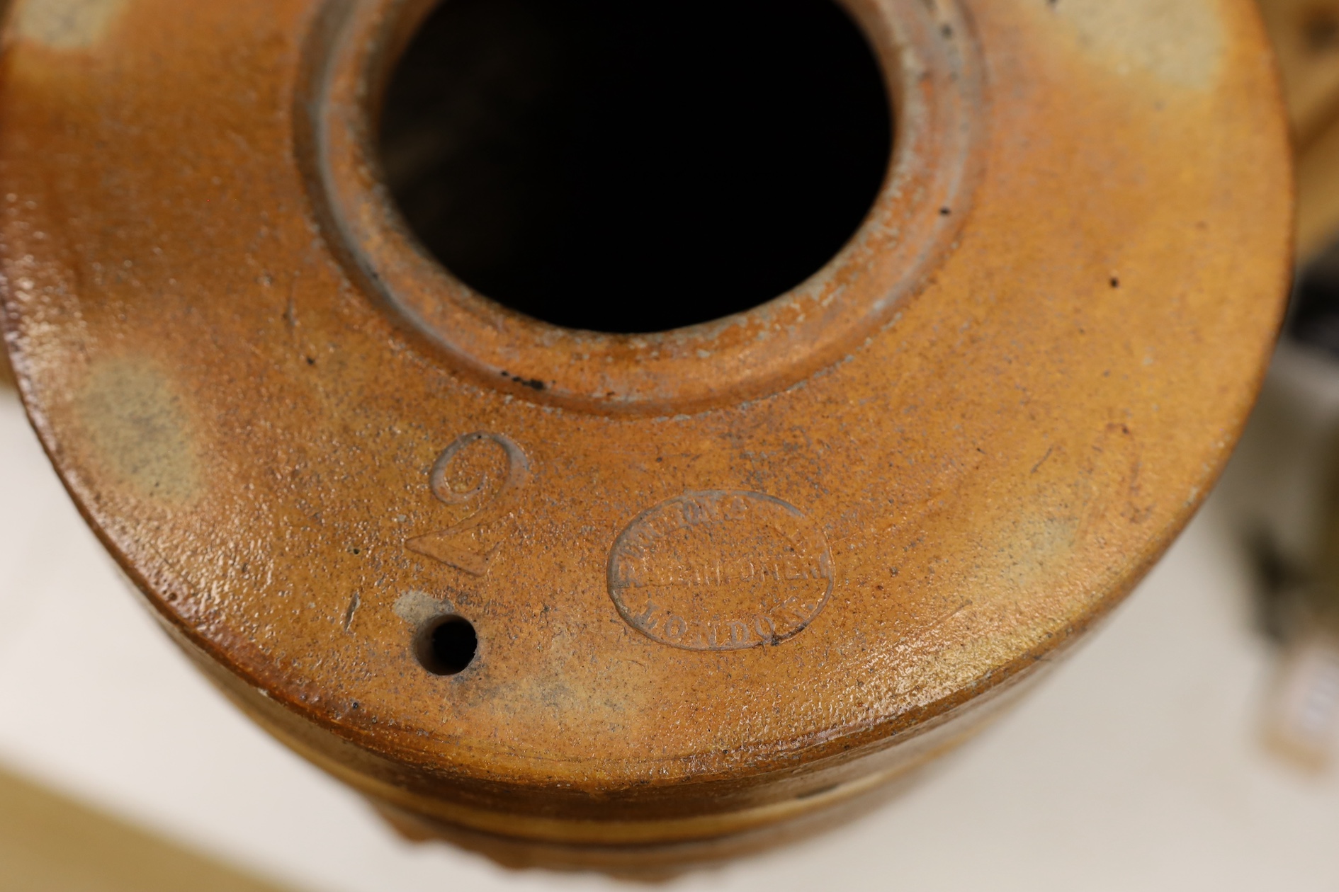 A Doulton and Watts stoneware spirit barrel, applied with the Royal coat of arms, 33.5cm high. Condition - some scratches in the glazing and marks on band by tap aperture